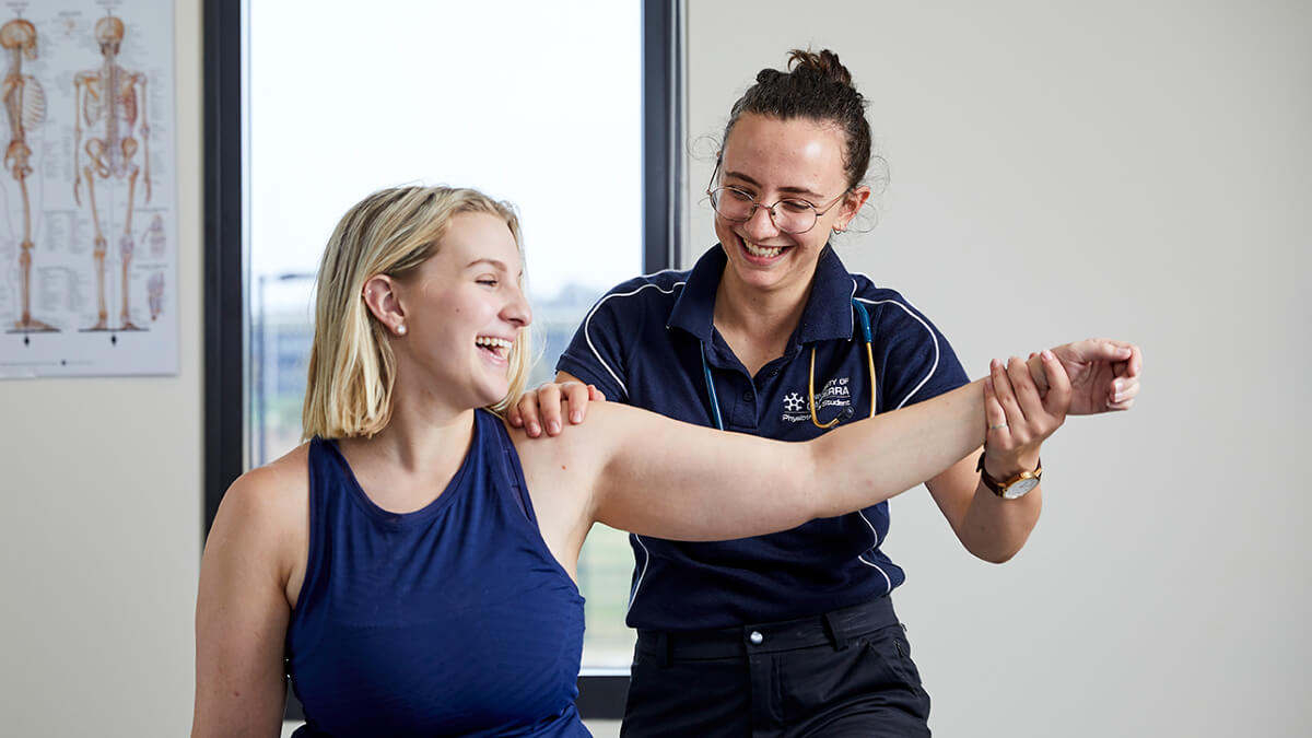 UC physiotherapy student treating female shoulder UC physiotherapy student treating female shoulder